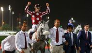 French jockey Olivier Peslier astride Yazeed celebrates after winning the Qatar Gold Sword at the Qatar Racing and Equestrian Club (QREC) yesterday.
