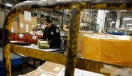 US Customs and Border Protection officer opens packages at the JFK mail facility in New York,  August 28, 2018. Reuters/Jill Kitchener
