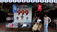 In this photo taken on March 25, 2019, Indian residents leave a clothing shop at the Kadherpettai wholesale textile market in the south Indian city of Tiruppur. AFP / Arun Sankar