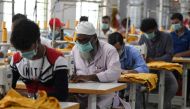 Indian labourers stitch apparel in the tailoring section of a textile production unit in the south Indian city of Tiruppur on March 25, 2019. AFP / Arun Sankar