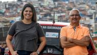 Brazilian Alvimar da Silva (R), creator of the JaUbra (Uber of slum) private transportation service, poses next to his daughter Aline Landim in Brasilandia, northern outskirts of Sao Paulo, Brazil, on February 27, 2019. AFP / Miguel Schincariol 