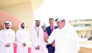 Minister of Transport and Communications H E Jassim bin Saif Al Sulaiti making the first 5G call as other officials look on at the National Museum of Qatar, yesterday.
