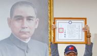 Terry Gou, founder and chairman of Foxconn, holds a testimonial next to a portrait of Sun Yat-sen, the founding father of Taiwan, as he announces seeking the nomination of Taiwan's opposition Kuomintang party to run for the island's presidency, in Taipei,