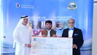 Dr R. Seetharaman, Group CEO of Doha Bank awarding a winner of Doha Bank’s Al Dana draw in Doha recently