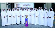 Qatar Airways officials pose for a group picture  with the Amir Cup during the Trophy Tour.