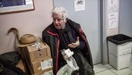 Retired tenor Achilleas Papadopoulos holds the medicines he received at the social pharmacy of Elliniko in this picture taken on February 27, 2019. AFP / Aris Messinis 