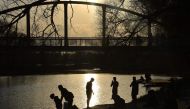 People rest in the park on the renovated embankment of the Vezelka river in the Russian city of Belgorod, some 700 km south of Moscow, on April 10, 2019.  AFP / Vasily Maximov 