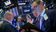 Traders work near the post where Uber is traded on the floor at the New York Stock Exchange (NYSE) in New York, May 10, 2019. (REUTERS/Brendan McDermid)