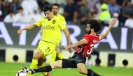 Al Sadd’s Baghdad Bounedjah vies for ball possession with an Al Rayyan player during the semi-final of the Amir Cup at the Jassim bin Hamad Stadium in Doha yesterday.