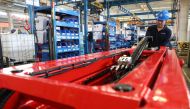:This photo taken on May 11, 2019 shows a worker with a hydraulic lift at a factory producing construction machinery for export to many countries, including the US, in Jinan, in east China's Shandong province. (AFP)