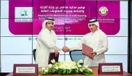 Salem bin Salim Al Mannai (right), Director of Corporate Affairs at the Ministry of Commerce and Industry, and Sheikh Ahmed bin Eid Al Thani, Head of  Qatar Financial Information Unit, at the MoU signing ceremony in Doha, yesterday. 