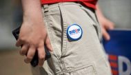 A supporter wears a pin on his shorts reading 