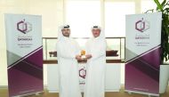 Ali Ibrahim Al Sulaiti (left), Public Relations Manager, Qatargas, receiving a commemorative trophy from Fahad Al Naimi, General-Secretary of Qatar Golf Association.