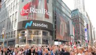 Julie Wainwright (C), CEO of The RealReal Inc. stands in Times Square to celebrate the company's IPO at the Nasdaq MarketSite in New York, U.S., June 28, 2019. Reuters/Lucas Jackson