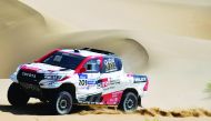 Qatar’ Nasser Al Attiyah and France’s Mathieu Baumel compete with their Toyota Hilux during the 9th stage of the Silk Way Rally 2019 from Alashan to Jiayuguan, yesterday. 
