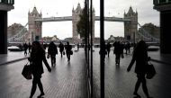 Workers walk through the More London business district with Tower Bridge seen behind in London, November 11, 2015. Reuters / Toby Melville