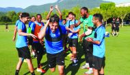 Al Sadd’s players sharing a light moment with their Algerian team-mate Baghdad Bounedjah as the feared striker returns to training in Olot, Spain, yesterday. 