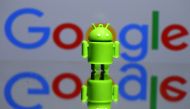 A 3D printed Android mascot, Bugdroid, seen in front of a Google logo in this illustration taken July 9, 2017. (REUTERS/Dado Ruvic/Illustration/File Photo)