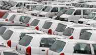 A worker adjusts the windscreen wipers of a parked car at a Maruti Suzuki stockyard on the outskirts of the western Indian city of Ahmedabad. (REUTERS/Amit Dave/File Photo)