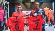 PSG players Kylian Mbappé (right) and Marco Verratti pose with the new away jersey for the new season.