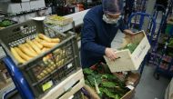 FILE PHOTO: Workers prepare boxes of fresh fruit and vegetables ahead of distribution from the warehouse of Natoora, a fruit and vegetable distribution company, in south London on December 5, 2018.   AFP / Daniel LEAL-OLIVAS 