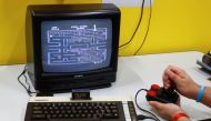A gamer plays Pac-Man, first released in 1980 on a historic Commodore 64 computer in the hall for retro games of Europe's leading digital games fair Gamescom, which showcases the latest trends of the computer gaming scene in Cologne, Germany, August 21, 2
