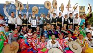 Mariachi dancers pose with the Guinness World Record of largest Mexican folk dance in Guadalajara, Jalisco state, Mexico, on August 24, 2019. AFP / Ulises Ruiz
