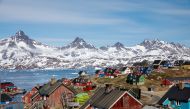 Snow covered mountains rise above the harbour and town of Tasiilaq, Greenland, June 15, 2018. Reuters/Lucas Jackson