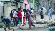 Kashmiris take cover as Indian security forces (unseen) fire teargas shells during clashes, after scrapping of the special constitutional status for Kashmir by the Indian government, in Srinagar, August 30, 2019. Reuters/Danish Ismail