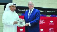 H E Ali bin Ahmed Al Kuwari, Minister of Commerce and Industry, receiving a memento from Michael Trick, Dean of Carnegie Mellon University in Qatar, after delivering the Dean’s Lecture Series, yesterday. Pic: Baher Amin/The Peninsula