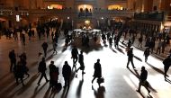 Commuters walk through the morning bright sunlight coming from the 60 feet high windows in Grand Central Terminal in New York City on March 11, 2019. AFP / Timothy A Clary