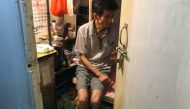 Luk Chin Tak sits in his room that he shares with his wife in a sub-divided apartment with six other residents in Kowloon, Hong Kong, ranked as the world's least affordable housing market. August 8, 2019. Thomson Reuters Foundation/Rina Chandran