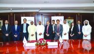 Commercial Bank and NBK Capital officials during the agreement signing ceremony.