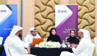 QNB officials and Open Career Day visitors at one of the help desks.