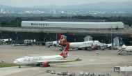 Virgin Atlantic aircraft taxi across the tarmac at Manchester Airport at Manchester Airport, northern England June 25, 2013. Reuters/Phil Noble