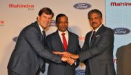Jim Farley, President of Ford New Businesses, Technology & Strategy, Pawan Goenka, Managing Director of Mahindra & Mahindra Limited, and Anand Mahindra, Chairman of Mahindra Group, join their hands after attending a news conference in Mumbai, India, Octob