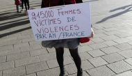 A woman holds a placard reading '21500 women victims of violence per year in France' as people gather for a rally at the Old Port of Marseille, southern France, on October 29, 2017. AFP / Franck Pennant