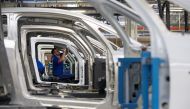 An employee works on the automobile assembly line of Bluecar electric city cars at Renault car maker factory in Dieppe, western France, September 1, 2015. Reuters / Philippe Wojazer