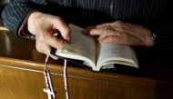 Representative image: A believer reads the bible during mass at St Josephs Church, a government-sanctioned Catholic church, in Beijing, China, October 1, 2018. Reuters / Thomas Peter
