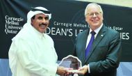 H E Sheikh Abdullah bin Saoud Al Thani (left), Governor of Qatar Central Bank, receiving a memento from the Dean of Carnegie Mellon, Michael Trick, during the Dean Lecture Series on “Qatar’s Strategy for Fintech” held at Carnegie Mellon University in Qata