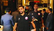 Qatari captain Hassan Al Haydos (left) and team-mates Almoez Ali and Akram Afif upon their arrival in Dhaka.