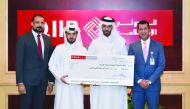 Omar Abdulaziz Al Meer (second left), QIIB Chief (Business Development); Zakaria Glaoui (right), Chief (Retail Banking) at QIIB; and Dr. Sudheer Nair (left), Country Manager –Visa Qatar with the final prize winner Abdulla Ojan Alkhayareen.