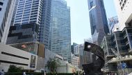 People walk past buildings in the financial business district of Raffles Place in Singapore on October 14, 2019. AFP / Roslan RAHMAN