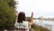 Duwamish Tribal Services Executive Director Jolene Haas holds up her hands, a traditional gesture of gratitude, on the banks of the Duwamish River in Seattle, USA. Thomson Reuters Foundation/Gregory Scruggs