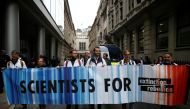 Protesters hold a banner outside the BlackRock office during an Extinction Rebellion demonstration in the City of London, Britain October 14, 2019. Reuters/Henry Nicholls