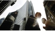 Pedestrians pass office blocks in the City of London, June 19, 2013. Reuters / Luke MacGregor
