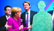German Minister of Labour and Social Affairs Hubertus Heil (L), German Chancellor Angela Merkel and German Transport Minister Andreas Scheuer (R) attend a presentation during their visit at the Digital Summit (Digital Gipfel) in Dortmund, western Germany,