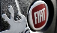 Logos of Peugeot and Fiat are seen in this illustration picture taken October 30, 2019. REUTERS/Regis Duvignau/Illustration
