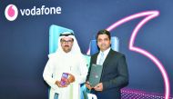 Vodafone Qatar’s Business Services Director, Mahday Saad Al Hebabi (left), and Mohammad Imran, General Manager of Prime Distribution and Trading Company, the exclusive distributors of OPPO in Qatar, holding the OPPO Reno 5G smartphone.