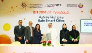 Yousuf Mohamed Al Jaida (third right), Chief Executive Officer, QFC, and Lana Khalaf (third left), Country Manager, Microsoft Qatar, and other officials during the signing ceremony.